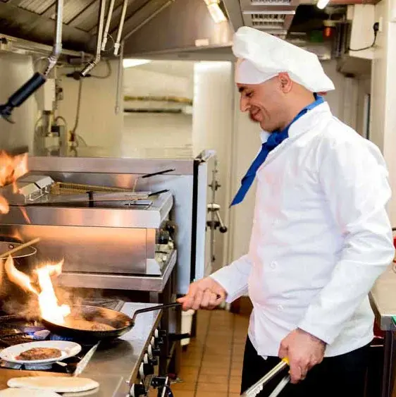 Marlton Gardens Chef Created Meals, chef frying a dish.