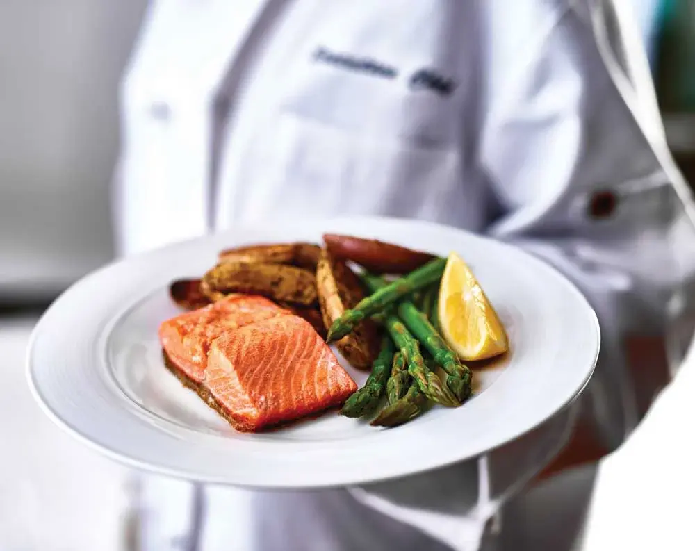 Marlton Gardens Chef Created Meals, chef delivering a finished dish.
