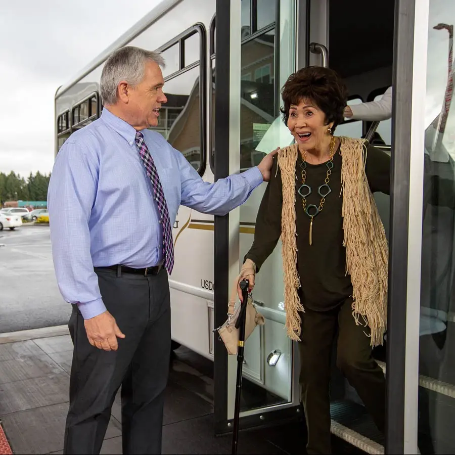Marlton Gardens man helping lady off bus
